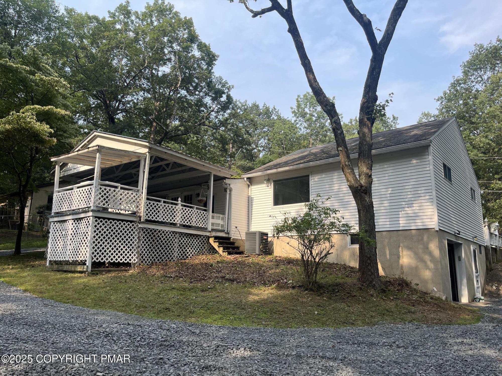 529 Pine Ridge Road Stroudsburg, PA 18360 - Photo 3 of 36 a front view of house with yard and trees in the background
