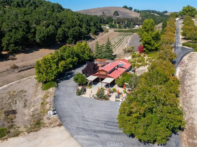 an aerial view of a house with a yard