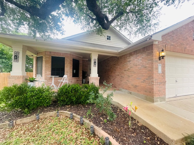 12316 Sugar Leaf Place Austin, TX 78748 - Photo 2 of 16 a view of a house with brick walls and potted plants
