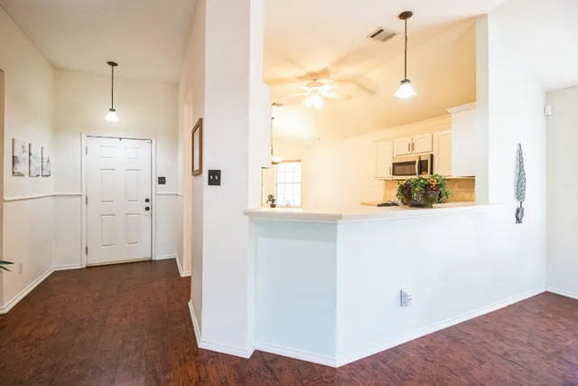 a view of a kitchen with wooden floor