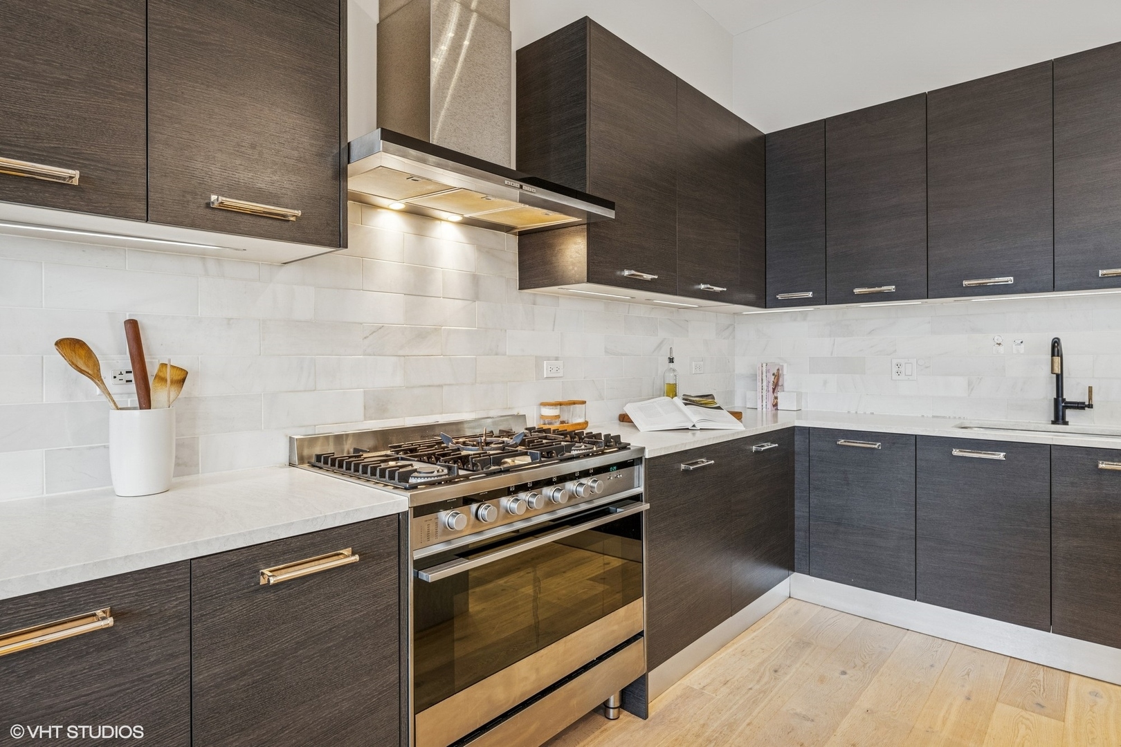 122 South Aberdeen Street, Unit 4S Chicago, IL 60607 - Photo 12 of 26 a kitchen with stainless steel appliances wooden cabinets and a stove top oven
