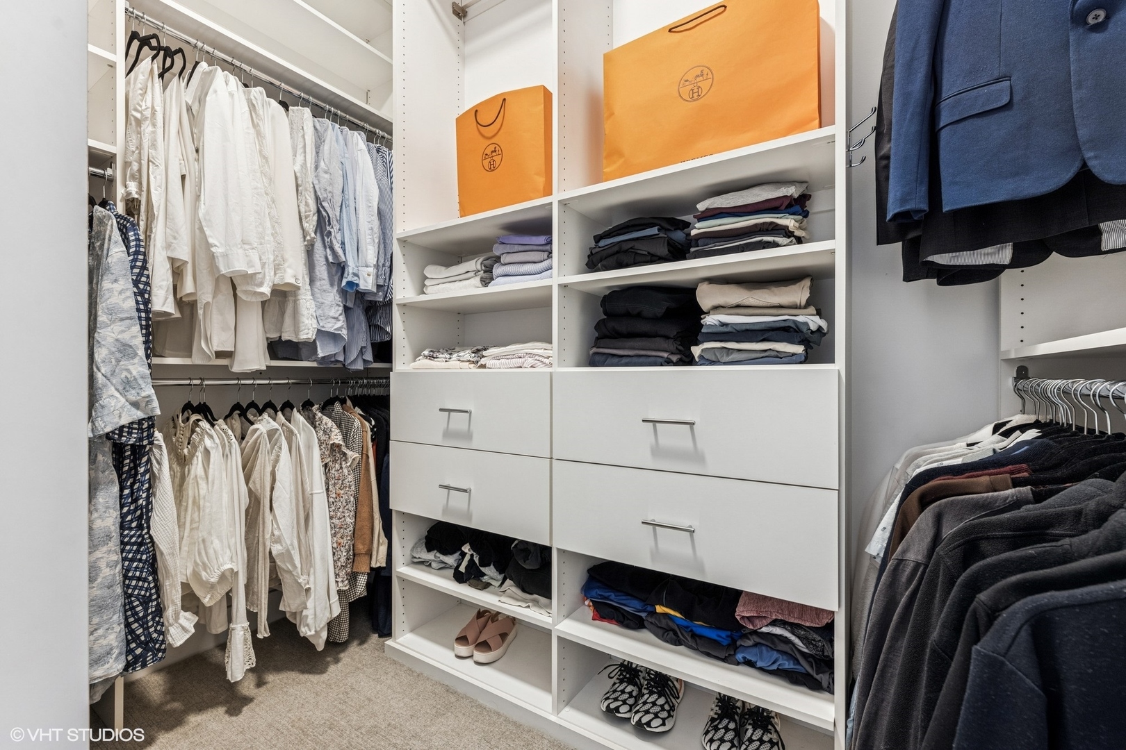 122 South Aberdeen Street, Unit 4S Chicago, IL 60607 - Photo 19 of 26 a view of walk in closet with clothes and shoes