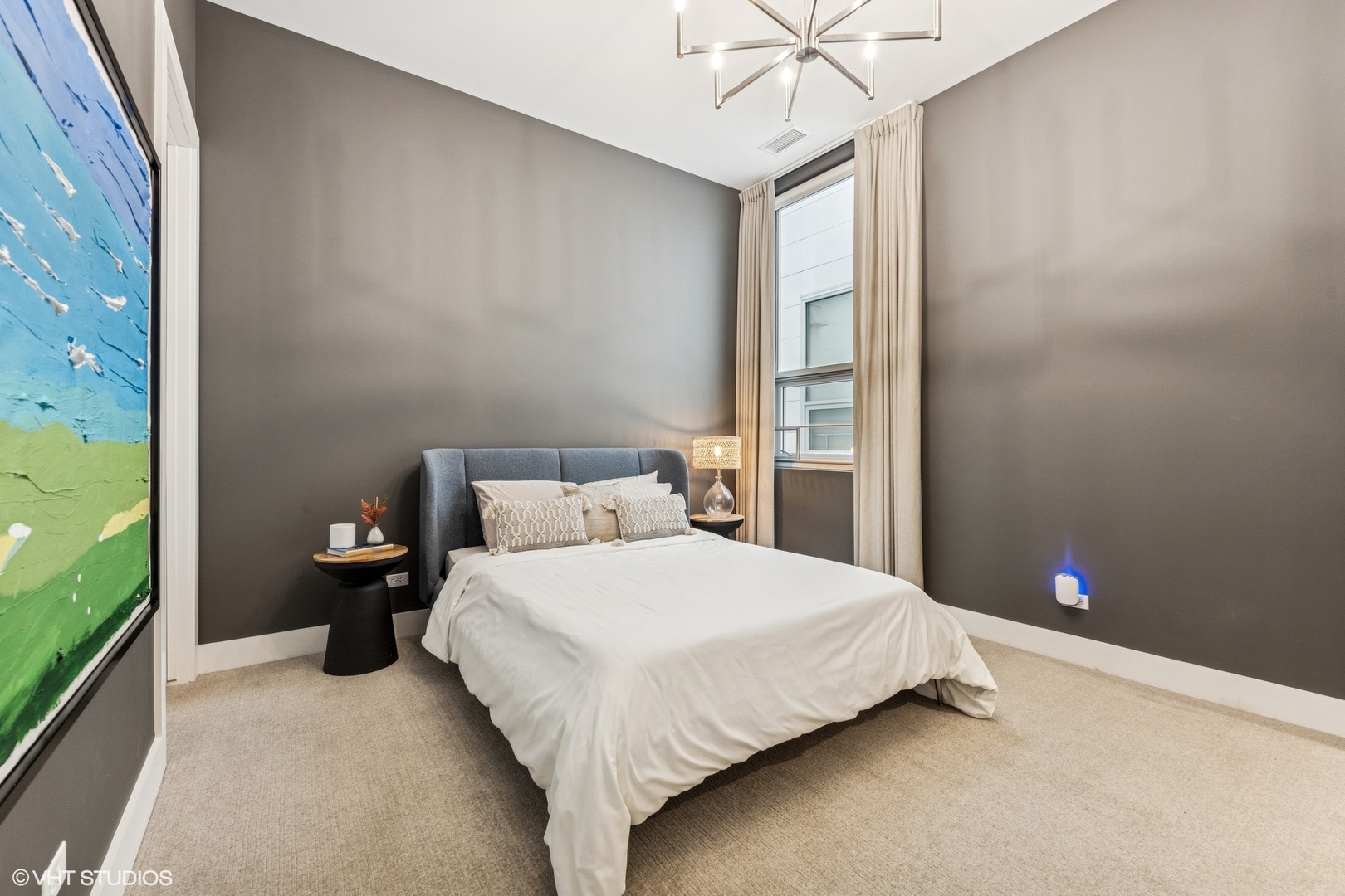 122 South Aberdeen Street, Unit 4S Chicago, IL 60607 - Photo 21 of 26 a bedroom with a bed and a chandelier