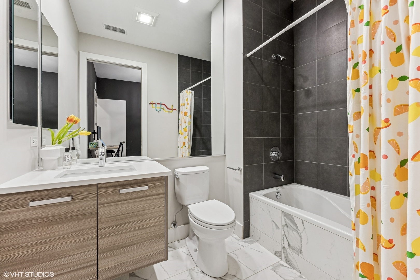 122 South Aberdeen Street, Unit 4S Chicago, IL 60607 - Photo 22 of 26 a bathroom with a sink a toilet a mirror and shower