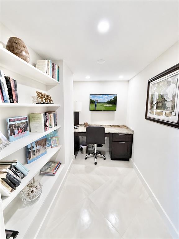 1050 Longboat Club Road, Unit 803 Longboat Key, FL 34228 - Photo 6 of 39 a bedroom with furniture and a book shelf