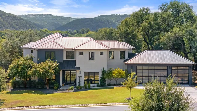a view of a house with a yard and sitting area
