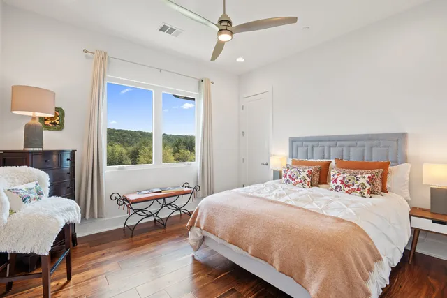 a bedroom with a bed a table and chair