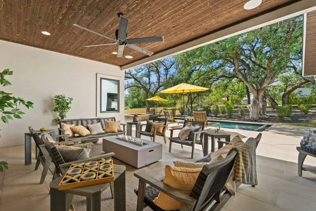 a view of a patio with a table and chairs under an umbrella