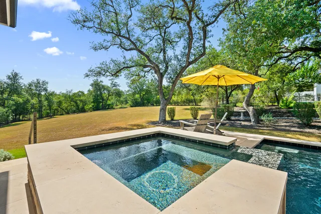 a view of swimming pool with chairs