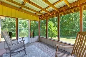 a view of porch with a table chairs and a porch