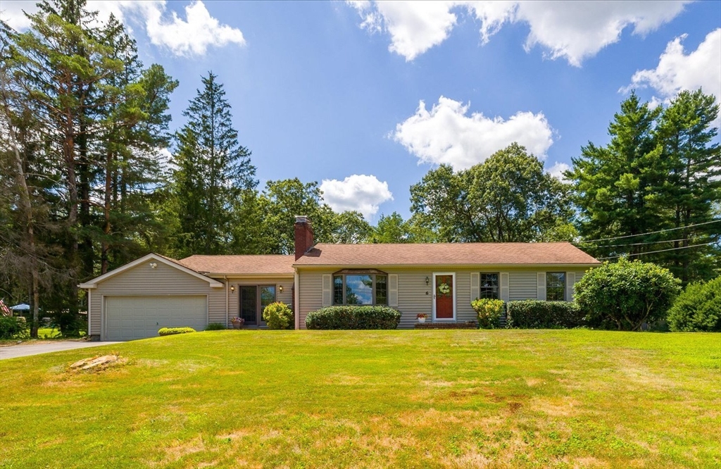 a front view of a house with yard and swimming pool