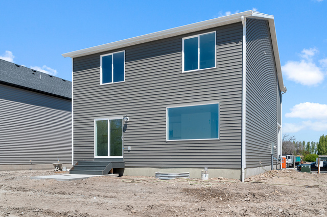 2829 North 710 West, Unit 15 Logan, UT 84321 - Photo 5 of 23 Two-story exterior featuring horizontal siding, white trim, and a concrete patio with steps