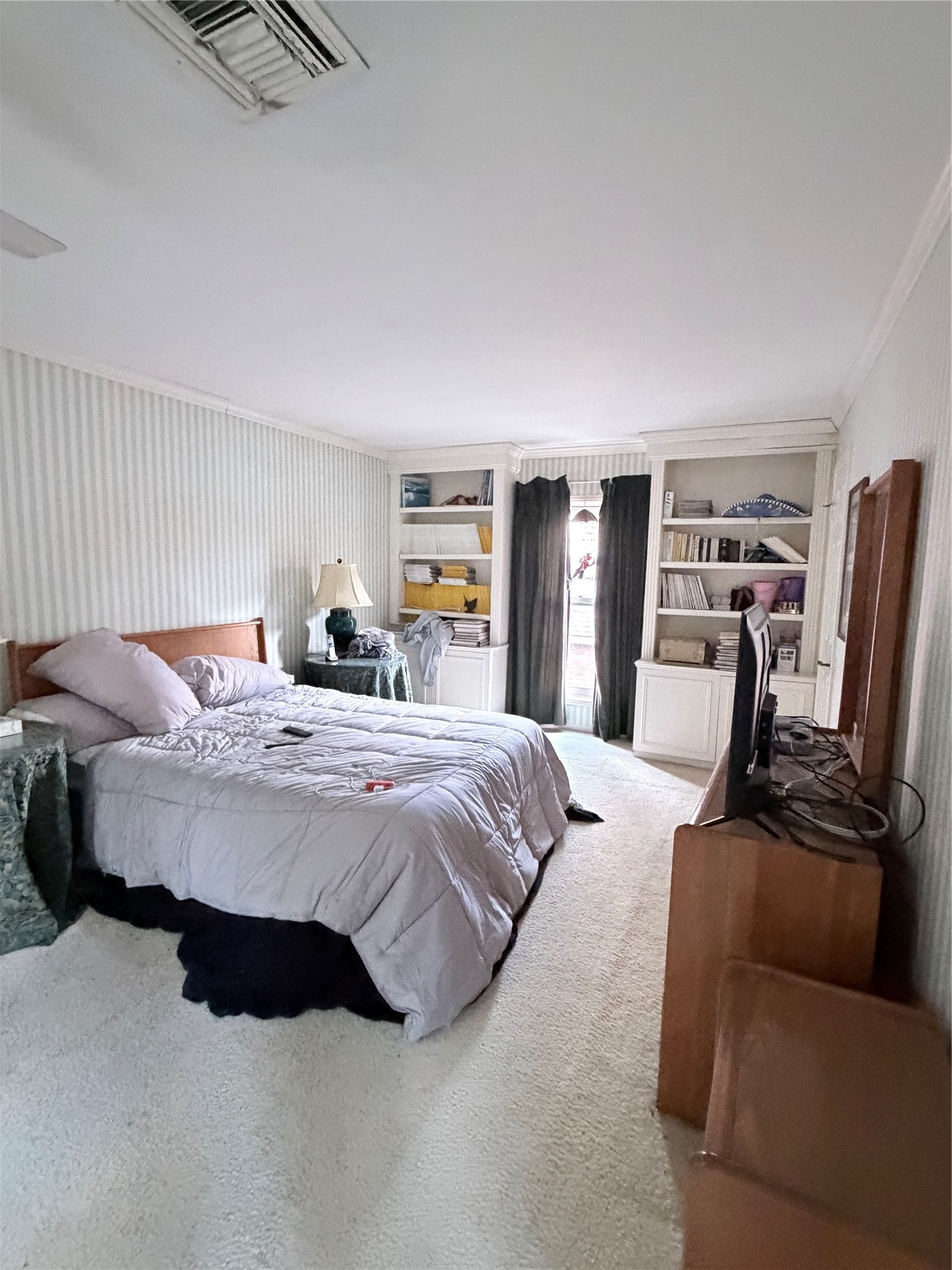 1499 Potomac Drive Houston, TX 77057 - Photo 10 of 21 a bedroom with a bed and wooden floor