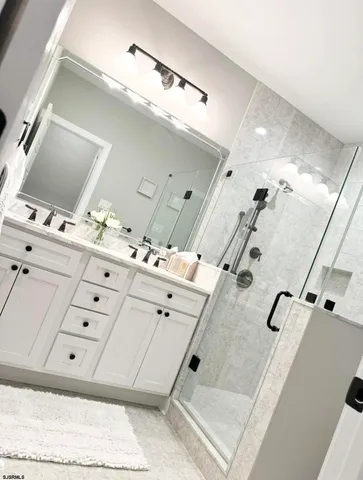 a view of a bedroom with wooden floor and windows