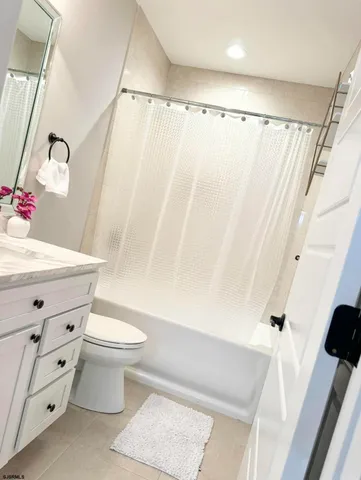 a bathroom with a bathtub and a window