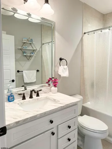 a bathroom with a sink vanity and a mirror