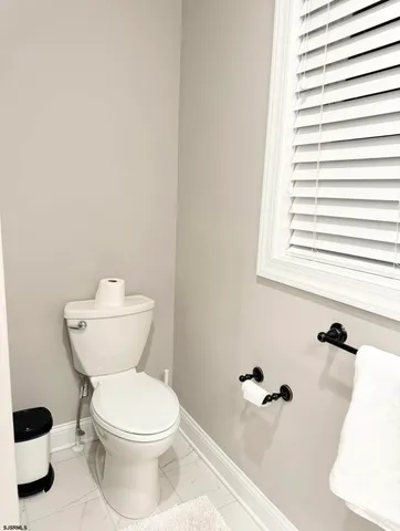 a spacious bedroom with a bed and a flat screen tv