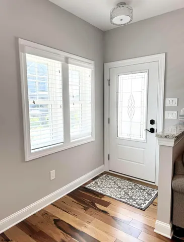 a living room with furniture a ceiling fan a flat screen tv and a fireplace