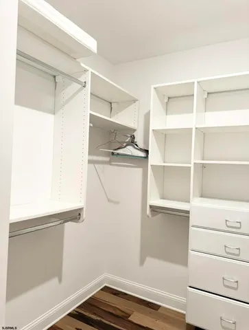 a bedroom with a large bed and a flat screen tv