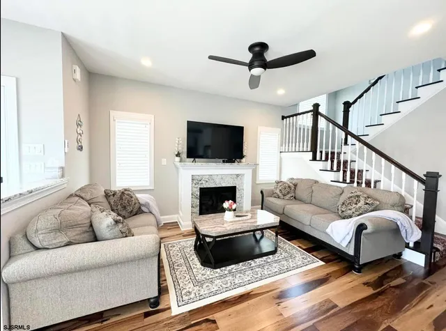 a living room with a fireplace and flat screen tv