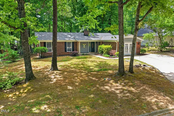 a view of a house with a tree in the yard