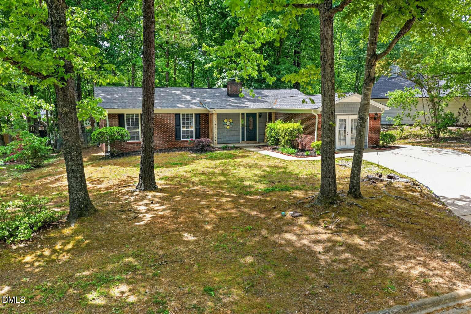 a view of a house with a tree in the yard