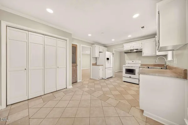 a kitchen with stainless steel appliances a refrigerator sink and cabinets