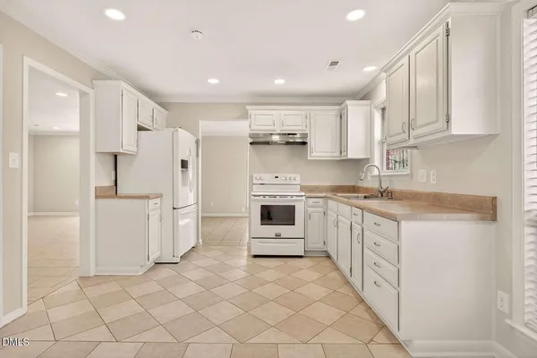 a large kitchen with cabinets and stainless steel appliances