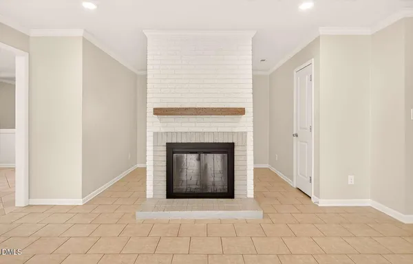 a living room with a fireplace and a rug