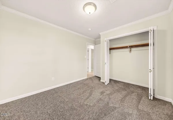an empty room with closet area
