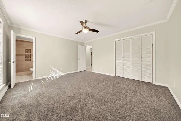 a view of an empty room with a ceiling fan