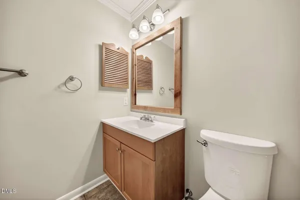 a bathroom with a sink toilet and mirror
