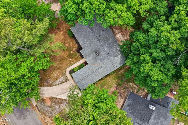 an aerial view of a house with a yard