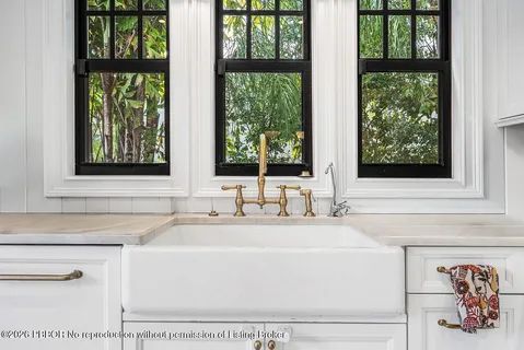 a stove top oven sitting inside of a kitchen