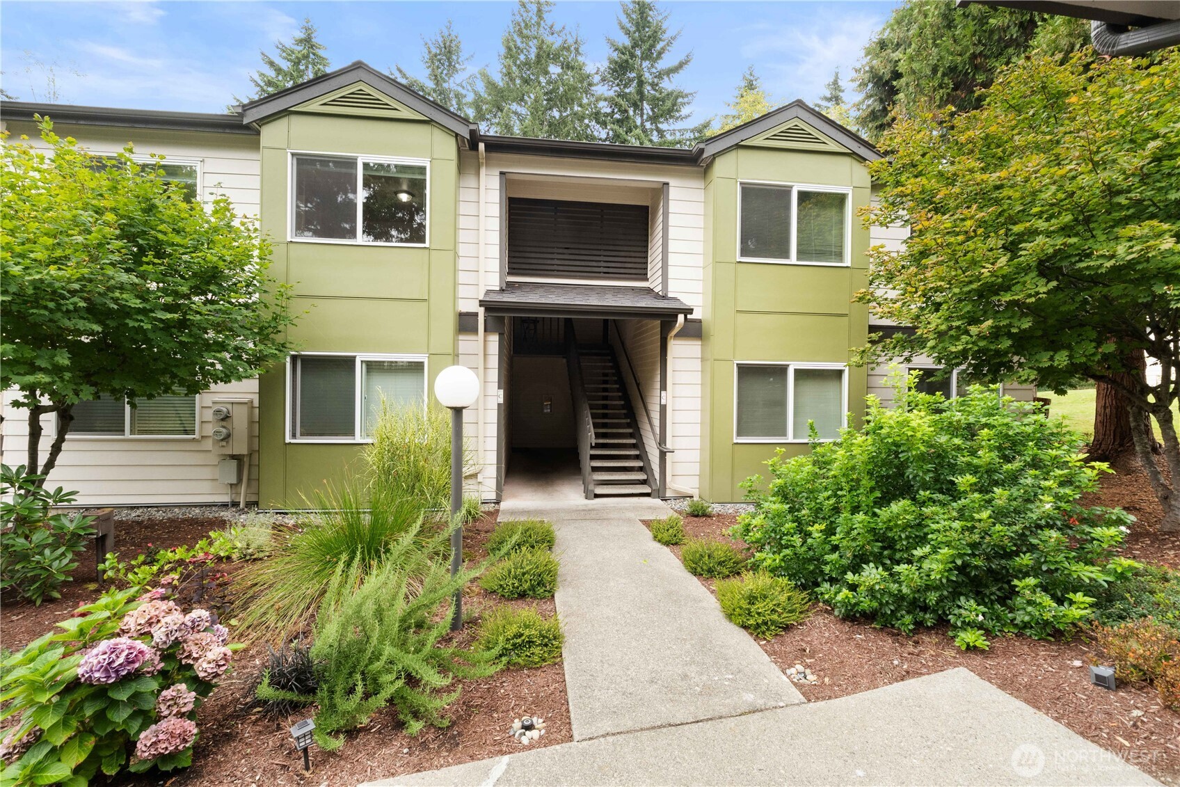 31500 33rd Place Southwest, Unit C203 Federal Way, WA 98023 - Photo 1 of 29 a front view of a house with a garden