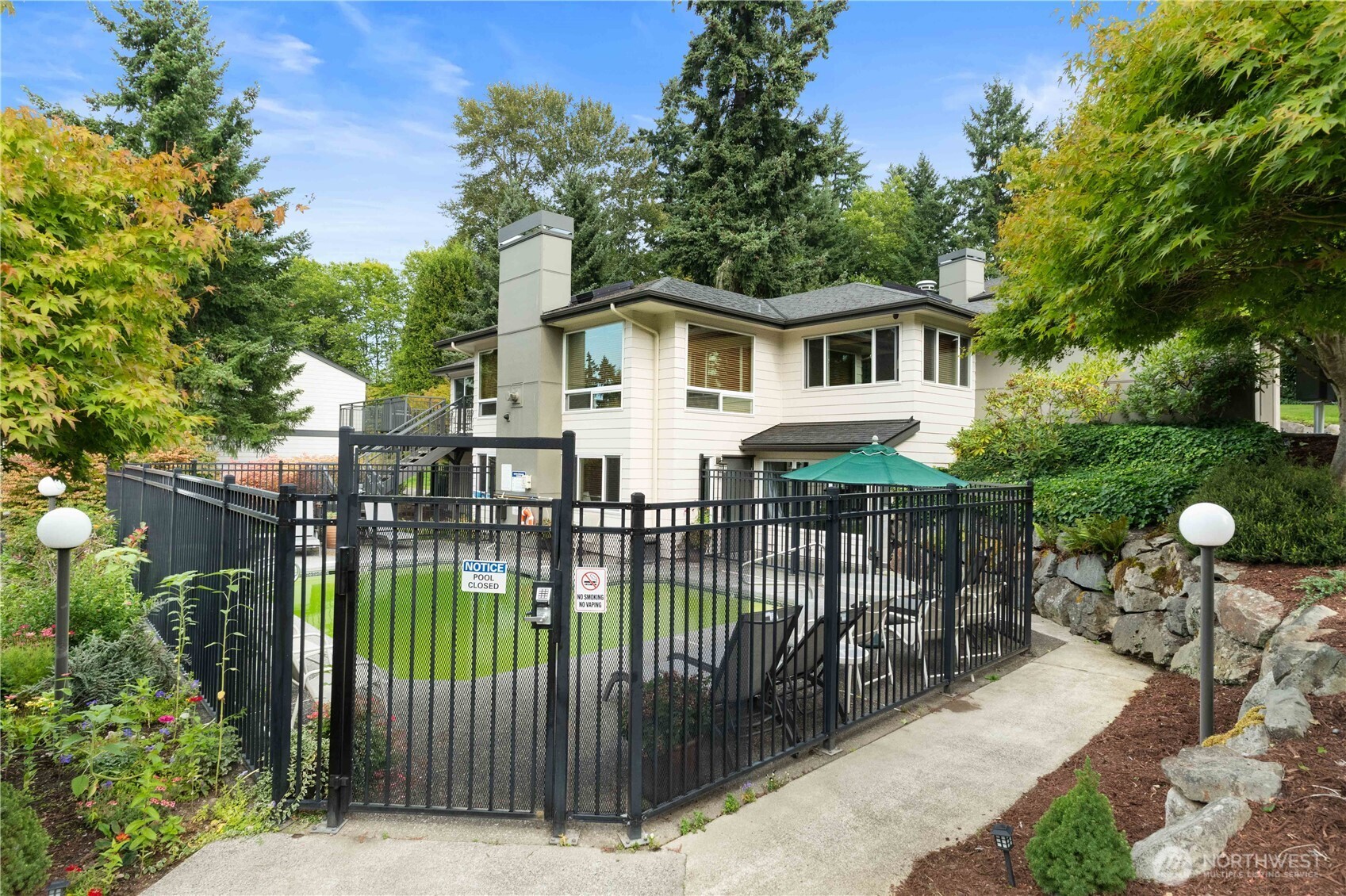 31500 33rd Place Southwest, Unit C203 Federal Way, WA 98023 - Photo 27 of 29 a view of a house with a wooden deck and furniture