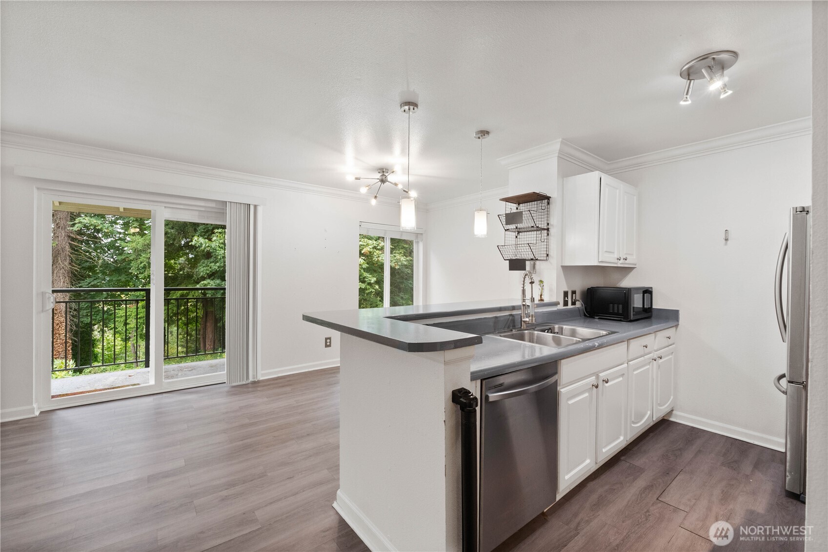 31500 33rd Place Southwest, Unit C203 Federal Way, WA 98023 - Photo 6 of 29 a kitchen with stainless steel appliances granite countertop a stove a sink and a refrigerator