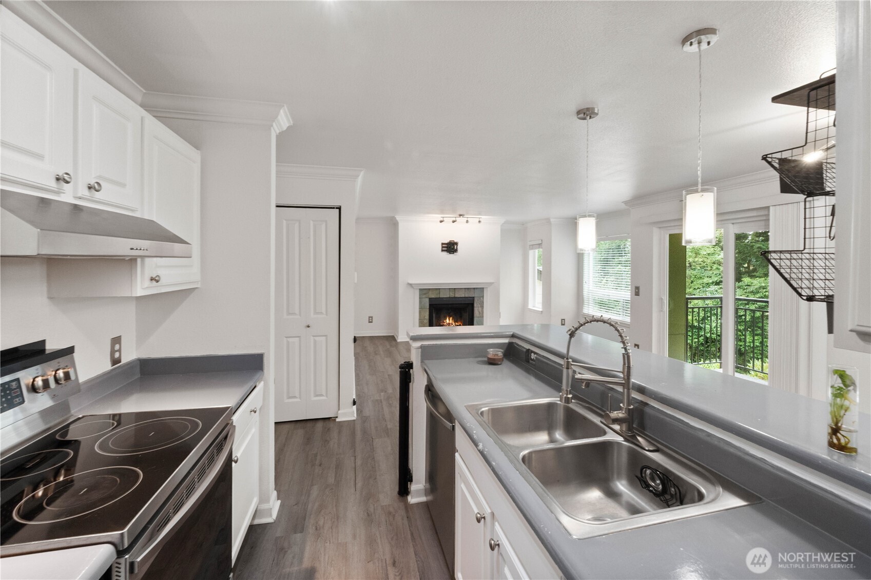 31500 33rd Place Southwest, Unit C203 Federal Way, WA 98023 - Photo 8 of 29 a kitchen that has a sink a stove and a wooden floors