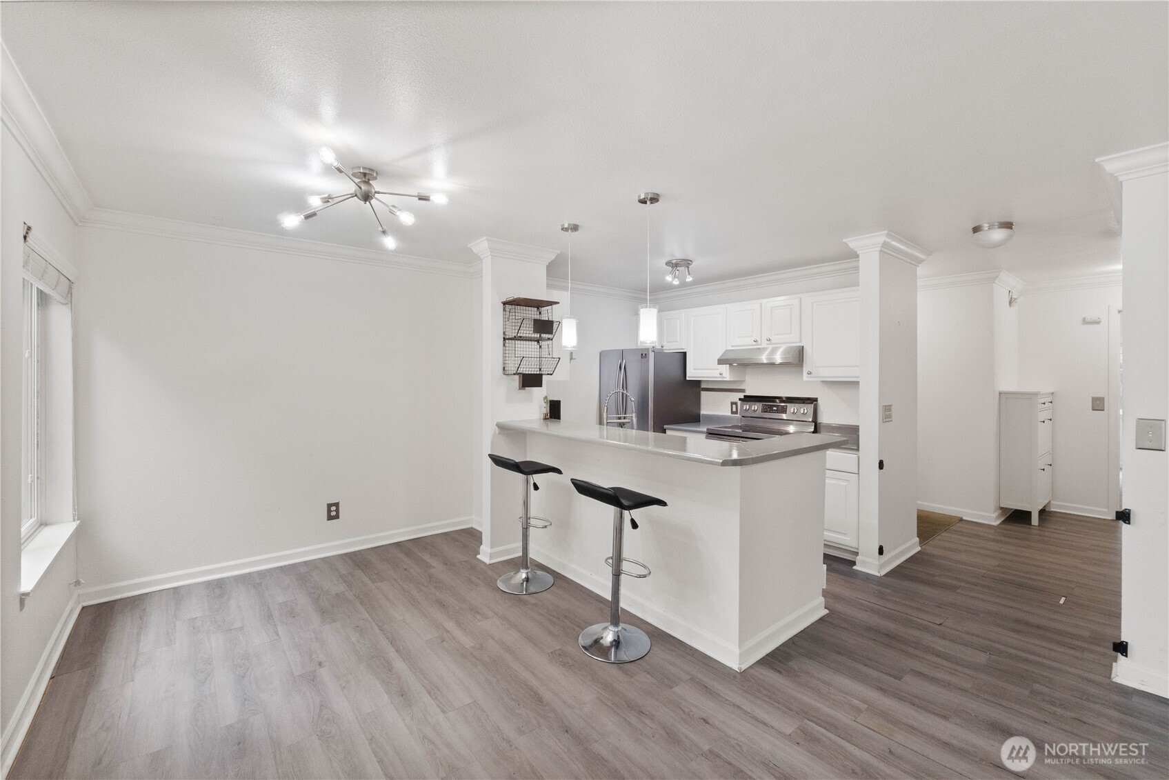 31500 33rd Place Southwest, Unit C203 Federal Way, WA 98023 - Photo 9 of 29 a kitchen with kitchen island stainless steel appliances cabinets a sink and a counter top space