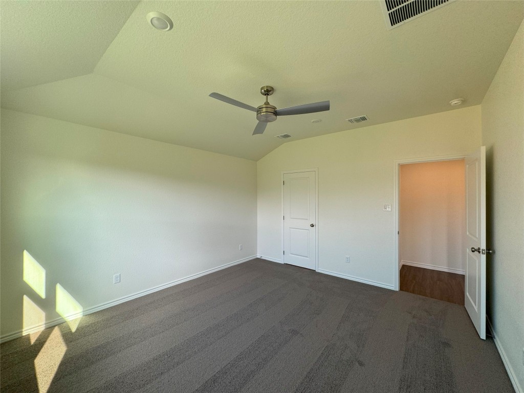 501 Double Vision Road Jarrell, TX 76537 - Photo 11 of 36 an empty room with a ceiling fan and wooden floor