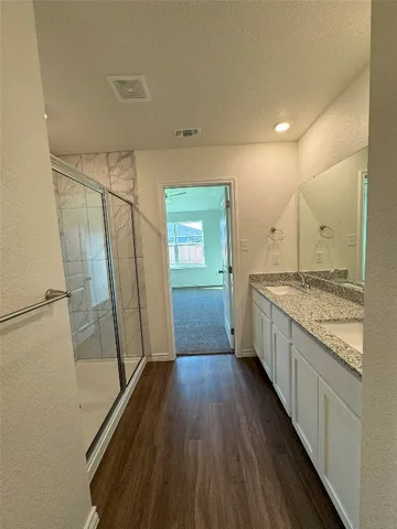 a view of a kitchen with wooden floor and electronic appliances