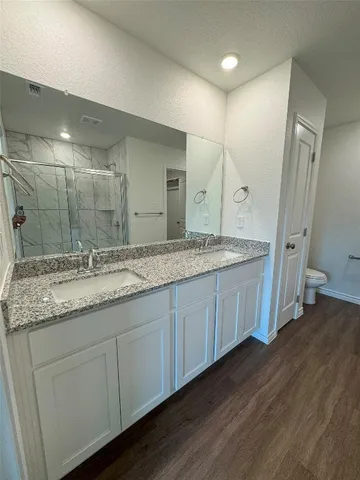 a bathroom with a granite countertop sink and mirror