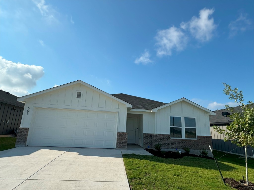 501 Double Vision Road Jarrell, TX 76537 - Photo 2 of 36 a front view of a house with a garden