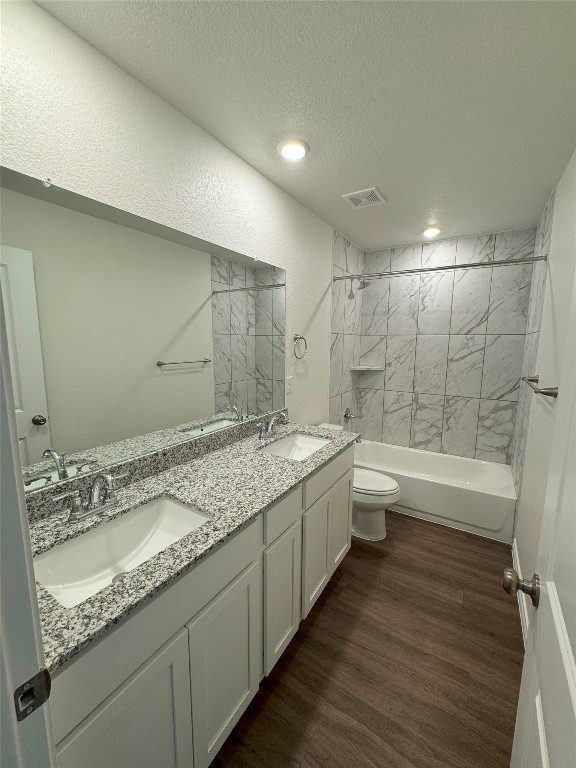501 Double Vision Road Jarrell, TX 76537 - Photo 22 of 36 a bathroom with a granite countertop sink a toilet and bathtub