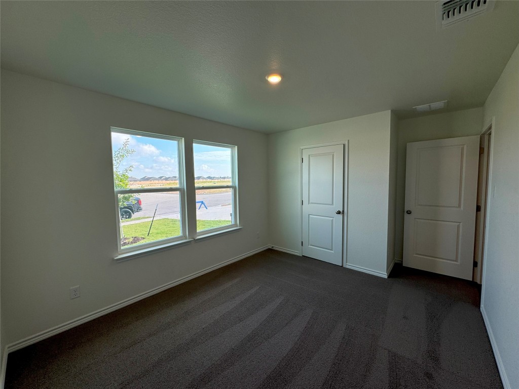 501 Double Vision Road Jarrell, TX 76537 - Photo 24 of 36 an empty room with wooden floor and windows