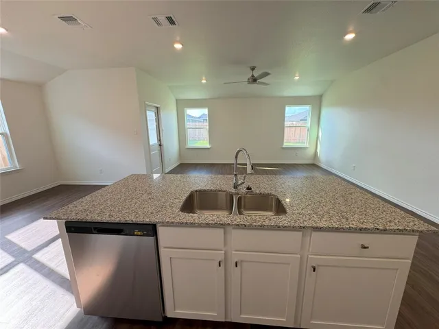 a bathroom with a granite countertop sink a mirror and window