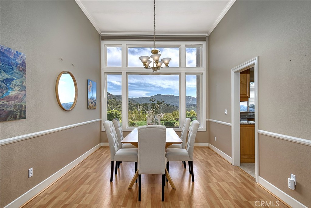 24932 Normans Way Calabasas, CA 91302 - Photo 12 of 63 a view of a dining room with furniture a chandelier and wooden floor