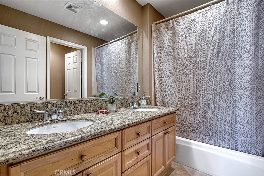 24932 Normans Way Calabasas, CA 91302 - Photo 40 of 63 a bathroom with a granite countertop sink and a mirror