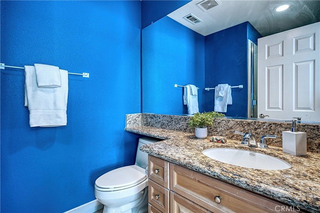 24932 Normans Way Calabasas, CA 91302 - Photo 43 of 63 a bathroom with a granite countertop toilet sink and mirror