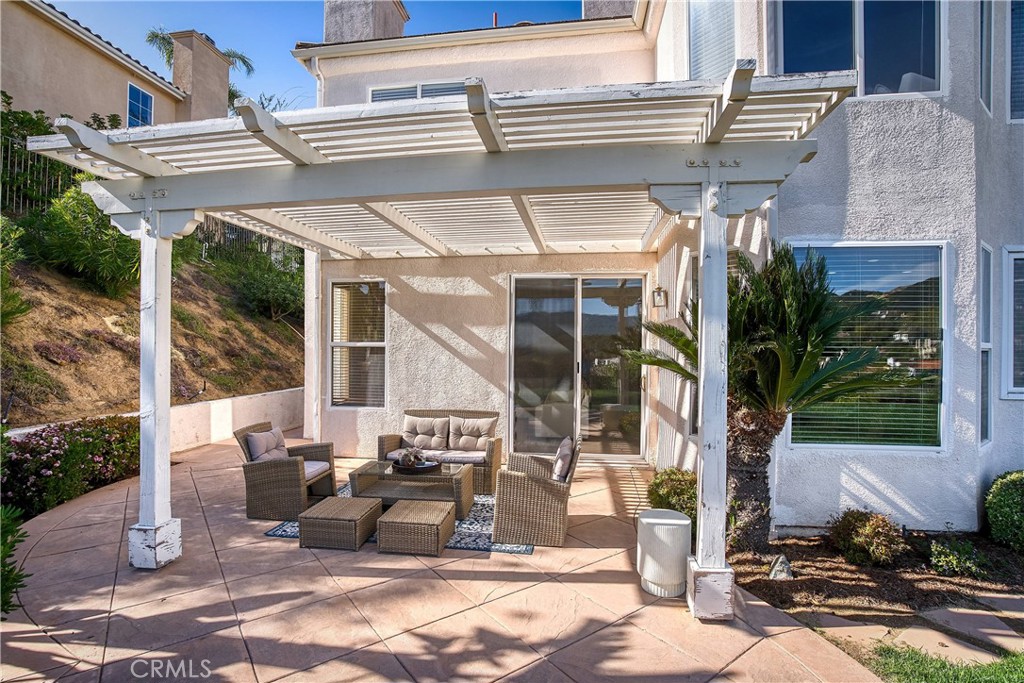 24932 Normans Way Calabasas, CA 91302 - Photo 44 of 63 a view of a patio with table and chairs and potted plants